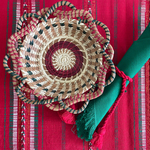 Christmas themed table setting, featuring Christmas Green napkin wrapped with Christmas Red napkin cord