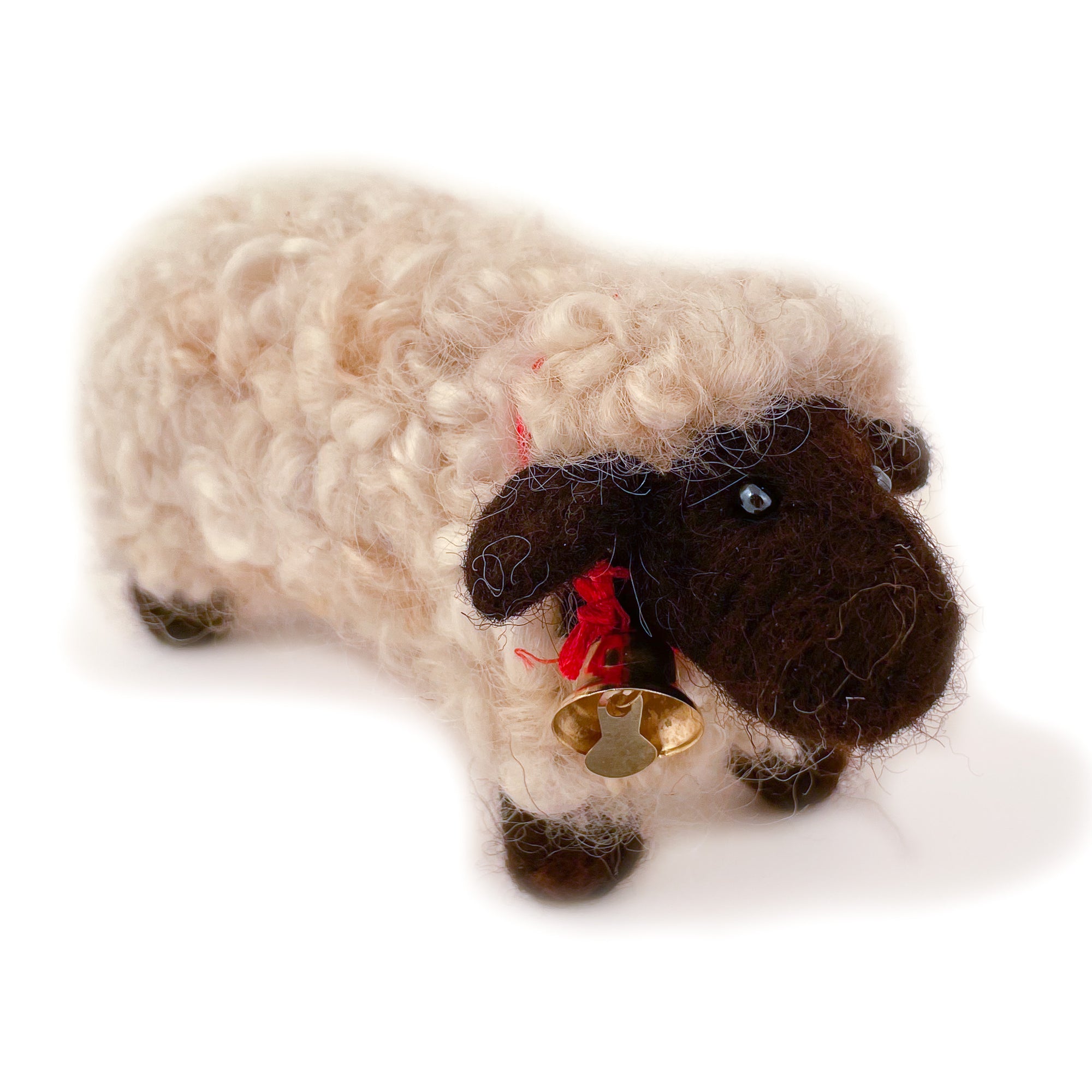 Felted wool sheep with brown wool face and feet and white wool body, with bell