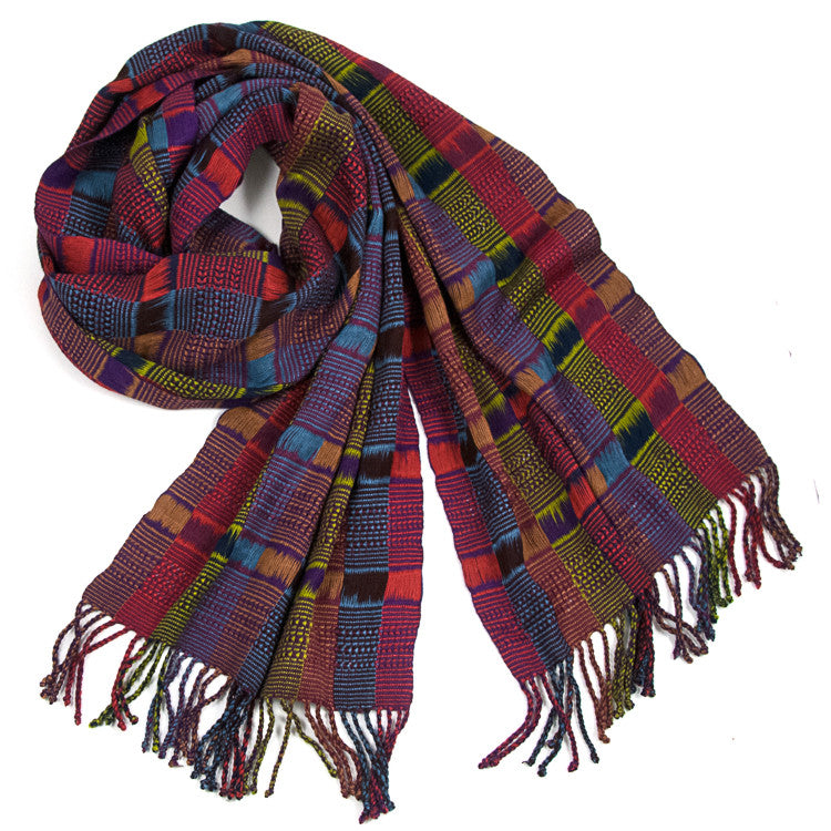 Angelina Scarf in Multicolor, made from rayon threads in blues, pinks, and greens, with twisted fringe. The scarf is laid flat, wrapped with a circle on white background.